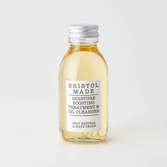 A 100ml clear glass bottle of Bristolmade bodyoil, a golden blend of nourishing oils for glowing and hydrated skin. 