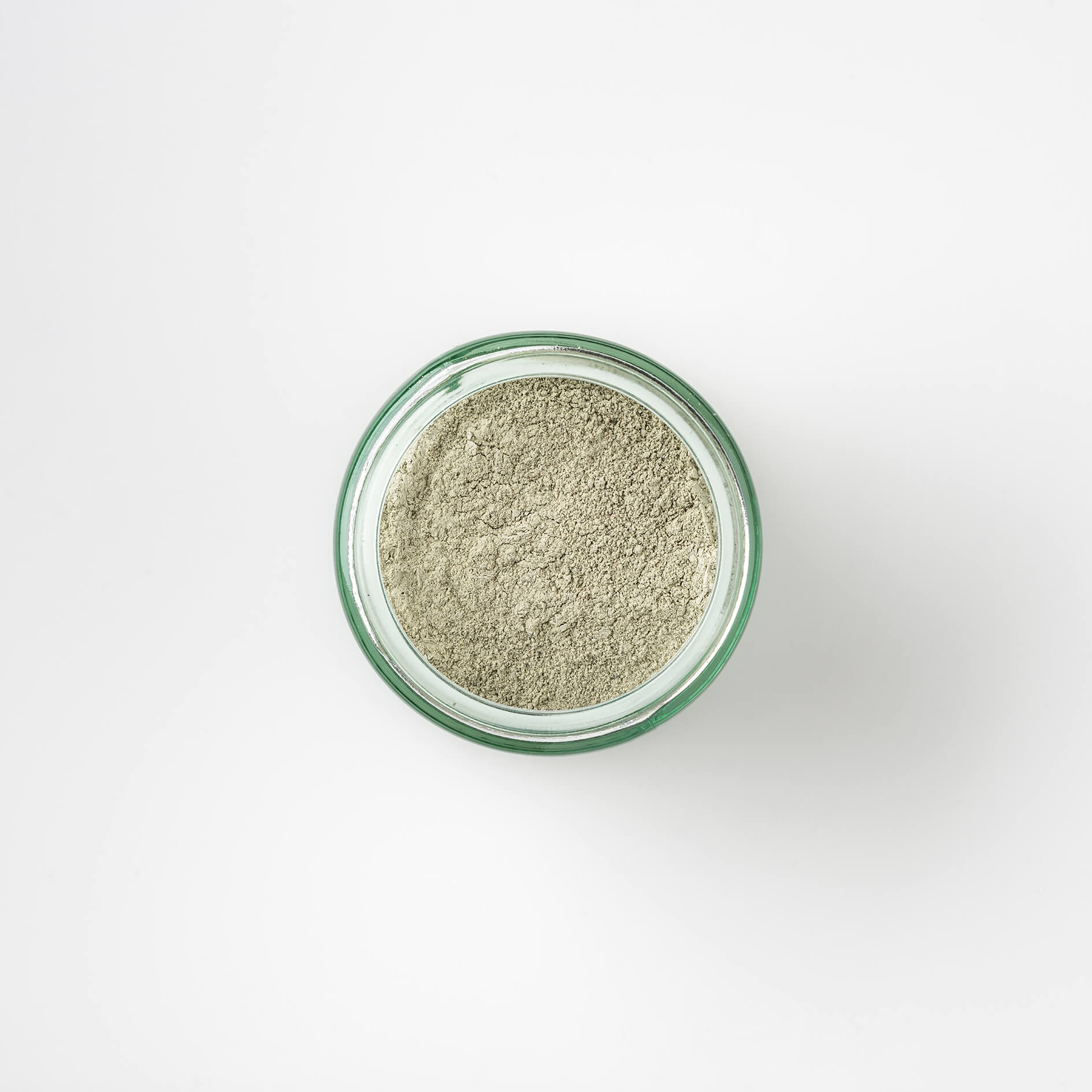 Top view of Bristolmade Green Clay Mask, showing the fine green powder, a blend of french clay and sea kelp for deep cleansing of the skin. 