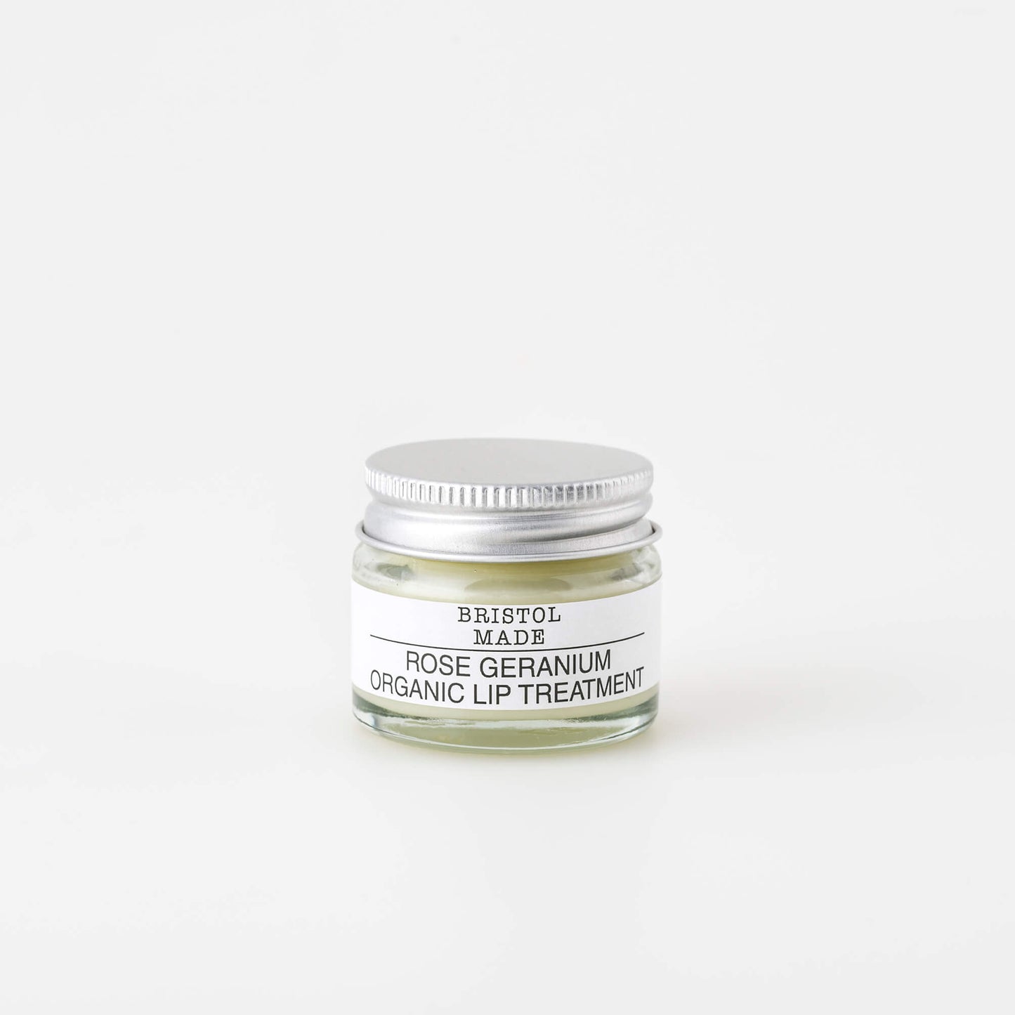 image of a bristolmade lip balm, part of a skincare set of three products. Packaged in a 15ml clear glass jar with a white label and black text detailing the ingredients.