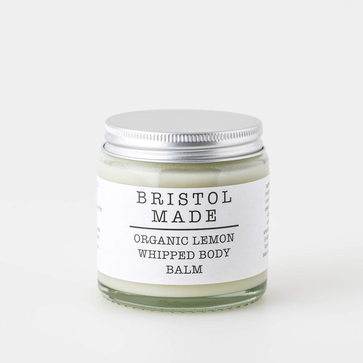 image of a Bristolmade body balm, showing the cream coloured product, in a sustainable 120ml clear glass jar. With a white label and black text, clearly showing the vegan ingredients and how to use the product.